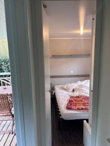 a small room with a small bed in it at Mobil-home climatisé 4 pers in Roquefeuil
