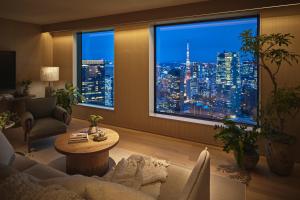 a living room with a view of a city at night at 1 Hotel Tokyo in Tokyo