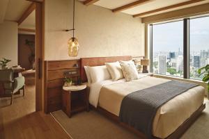 a bedroom with a large bed and a large window at 1 Hotel Tokyo in Tokyo