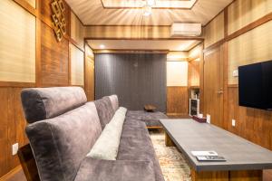 a living room with a couch and a table at Tomiken in Nozawa Onsen
