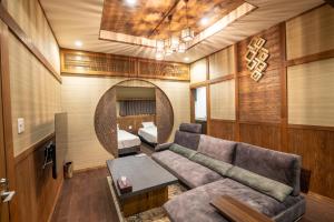 a living room with a couch and a bed at Tomiken in Nozawa Onsen
