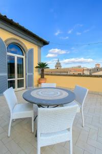 a patio with a table and chairs on a patio at SanFa Roof in Viterbo