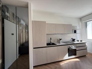 a kitchen with a sink and a stove at Appartamento Aurora in Pordenone