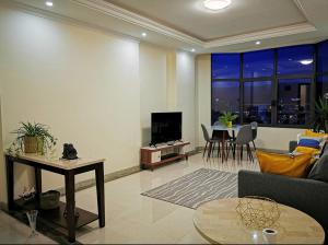 a living room with a couch and a table at Central Location, Breathtaking Views! in Addis Ababa