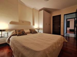 a bedroom with a large bed with two pillows at Central Location, Breathtaking Views! in Addis Ababa