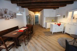 a dining room with a table and chairs and a kitchen at Casa Nora Apartments in Gorizia