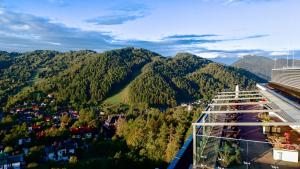 a view of a mountain from a balcony of a building at Hotel Pieniny Grand Wellness & SPA - Destigo Hotels in Szczawnica +48 photos