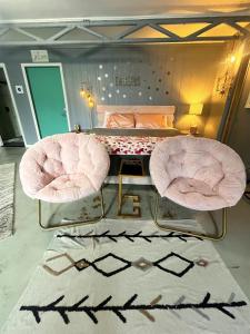 a bedroom with two chairs and a bed at The Studio at Stardust Retreat in Coleman