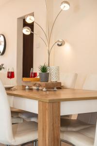 a dining room table with a lamp and chairs at Bluewave Apartment in Pyla