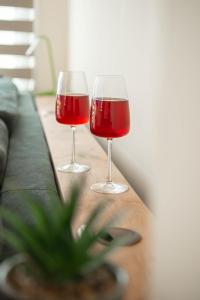 two glasses of red wine sitting on a table at Bluewave Apartment in Pyla