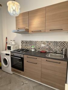 a kitchen with a stove and a sink at House - Cesare Balbo - Too in Rome