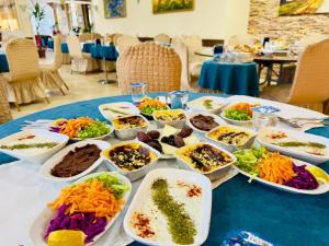 a table with a bunch of bowls of food on it at Havza Tuğra Otel in Havza