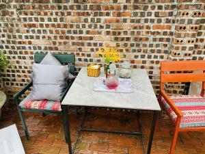 a table with a plate of food and two chairs at An Homestay Tam Coc in Ninh Binh