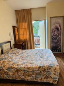 a bedroom with a large bed and a window at Super Budget 3 Rooms Apartment @ Brinchang Town in Brinchang