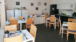 a restaurant with tables and chairs and a kitchen at Hotel Schillerquartier in Kassel