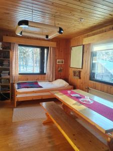 a room with a bed and a table in a cabin at Aurora Cabin in Saariselka +32 photos