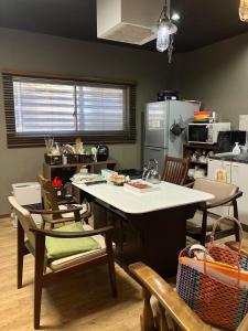 a kitchen with a table and chairs in a kitchen at Togawa Nojuku - Vacation STAY 49387v in Tuyama
