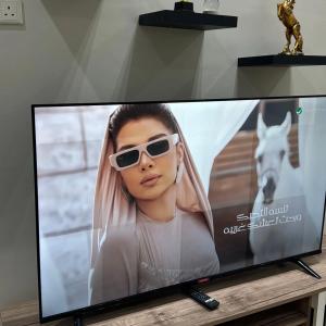 a television screen with a woman wearing sunglasses at الزعفران in Amman