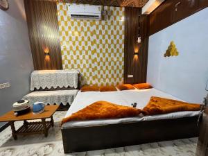 a bedroom with a bed and a table in it at Mangal kripa homestay in Ujjain +42 photos