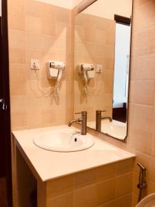 a bathroom with a sink and a mirror at Capital Wind Beach Cabanas in Kalpitiya