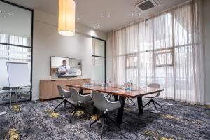 a meeting room with a table and chairs and a screen at Somerset Westview Nairobi All Suites in Nairobi +45 photos