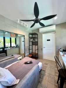 a bedroom with two beds and a ceiling fan at Stylish Villa Alma 18 Guests - Pool, KTV & BBQ in Simpang Ampat +86 photos