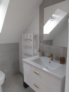 a white bathroom with a sink and a mirror at Disneyland Paris dream 2 rooms & breakfast in Magny-le-Hongre