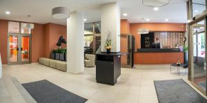 a lobby of a building with a counter and chairs at Hotel Junior Poděbrady in Poděbrady