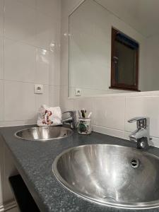 a silver sink in a bathroom with a mirror at Tignes 2100 - Les Flocons - Vue panoramique in Tignes +28 photos