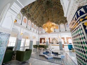 a room with a table and chairs and a chandelier at Pickalbatros SUNGO Club - All Inclusive in Marrakech