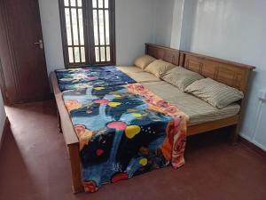 a bed in a room with a bedspread on it at Blessed guest Nuwara eliya in Nikawatawana