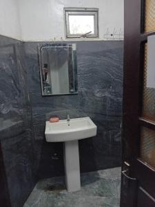 a bathroom with a sink and a mirror at Blessed guest Nuwara eliya in Nikawatawana