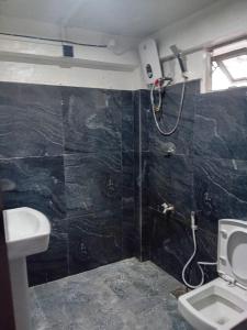 a bathroom with a shower and a toilet and a sink at Blessed guest Nuwara eliya in Nikawatawana