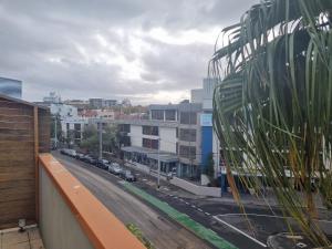 a view of a city street from a balcony at Nomads St Kilda in Melbourne