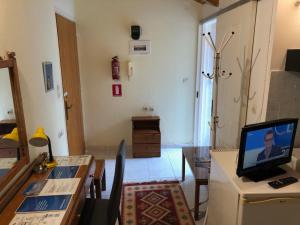 a living room with a television on a table at Ion Apartments Messolonghi Single Bed Room Mountain View Loft in Mesolongion