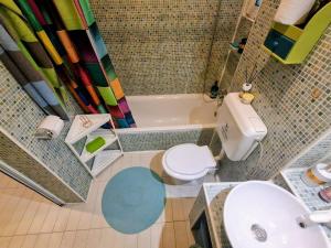 a bathroom with a toilet and a sink and a tub at Artsy fully equipped 2 bedrooms House all to yourself! in Bucharest