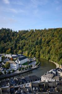 an aerial view of a town next to a river at Hôtel Panorama - Vue exceptionnelle sur la Semois in Bouillon