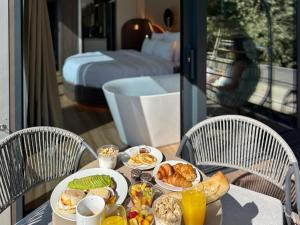 a table with plates of breakfast food on it at L'Escale Royale Verneuil-sur-Seine in Verneuil-sur-Seine