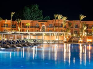 a hotel with a swimming pool at night at Pickalbatros SUNGO Club - All Inclusive in Marrakech