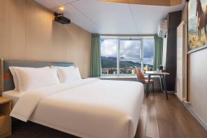 泰安市にあるWonderful Beginningの大きな白いベッドと窓のある寝室