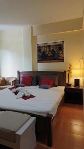 a bedroom with a large bed with red pillows at The Sunshine hostel and hotel in Ko Lanta