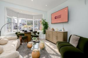 a living room with a couch and a table at Greenford Apartments in Perivale