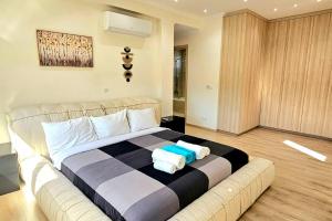 a bedroom with a large bed with towels on it at Pareklisia Mystical Haven in Parekklisha +25 photos