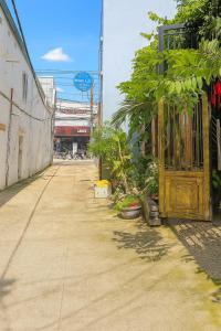 an empty street with trees and a yellow door at Hồng Lực Hotel HCM in Ho Chi Minh City