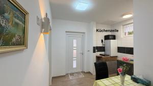 a living room with a table and a kitchen at Kim Homestay B Zimmer B1 in Sömmerda