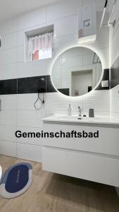 a bathroom with a white sink and a mirror at Kim Homestay B Zimmer B1 in Sömmerda