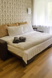 ein großes Bett mit zwei Handtüchern darauf in einem Schlafzimmer in der Unterkunft Friendly two-room apartment in Sigulda