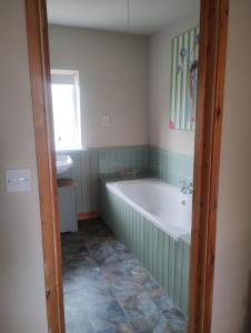 a bathroom with a tub and a sink at Peaceful 1 Bed Self-Contained Property with Parking in Wivenhoe