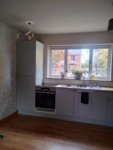 a kitchen with a white refrigerator and a window at Peaceful 1 Bed Self-Contained Property with Parking in Wivenhoe +8 photos