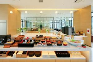 a buffet line with many different types of food at Candeo Hotels Kobe Tor Road in Kobe +35 photos